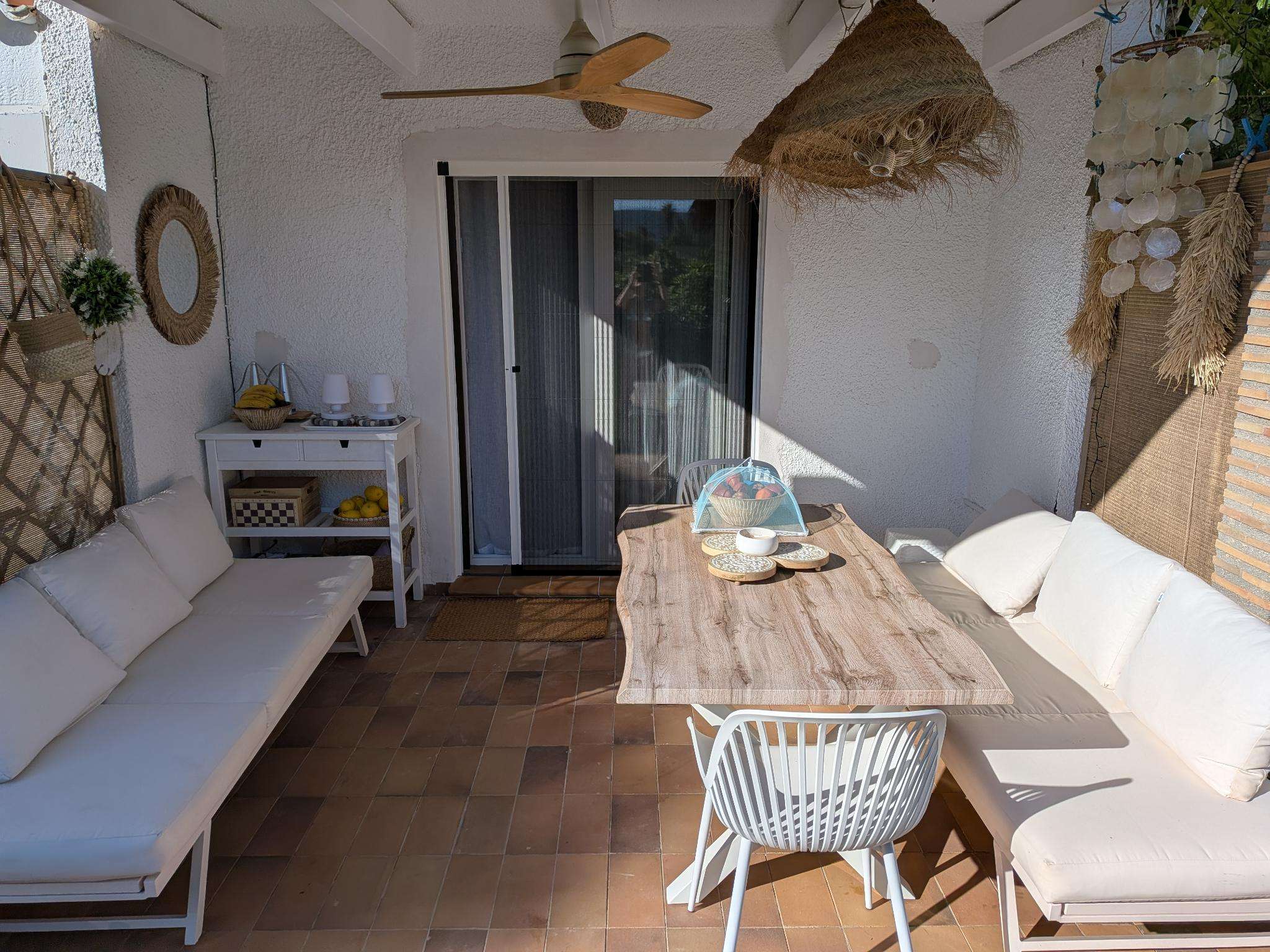 Covered terrace with lounge seating and dining table